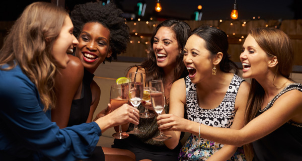 Ladies enjoying cocktails at a party event. Our chauffeuring service offers flexibility, so you can party without worrying about getting home.